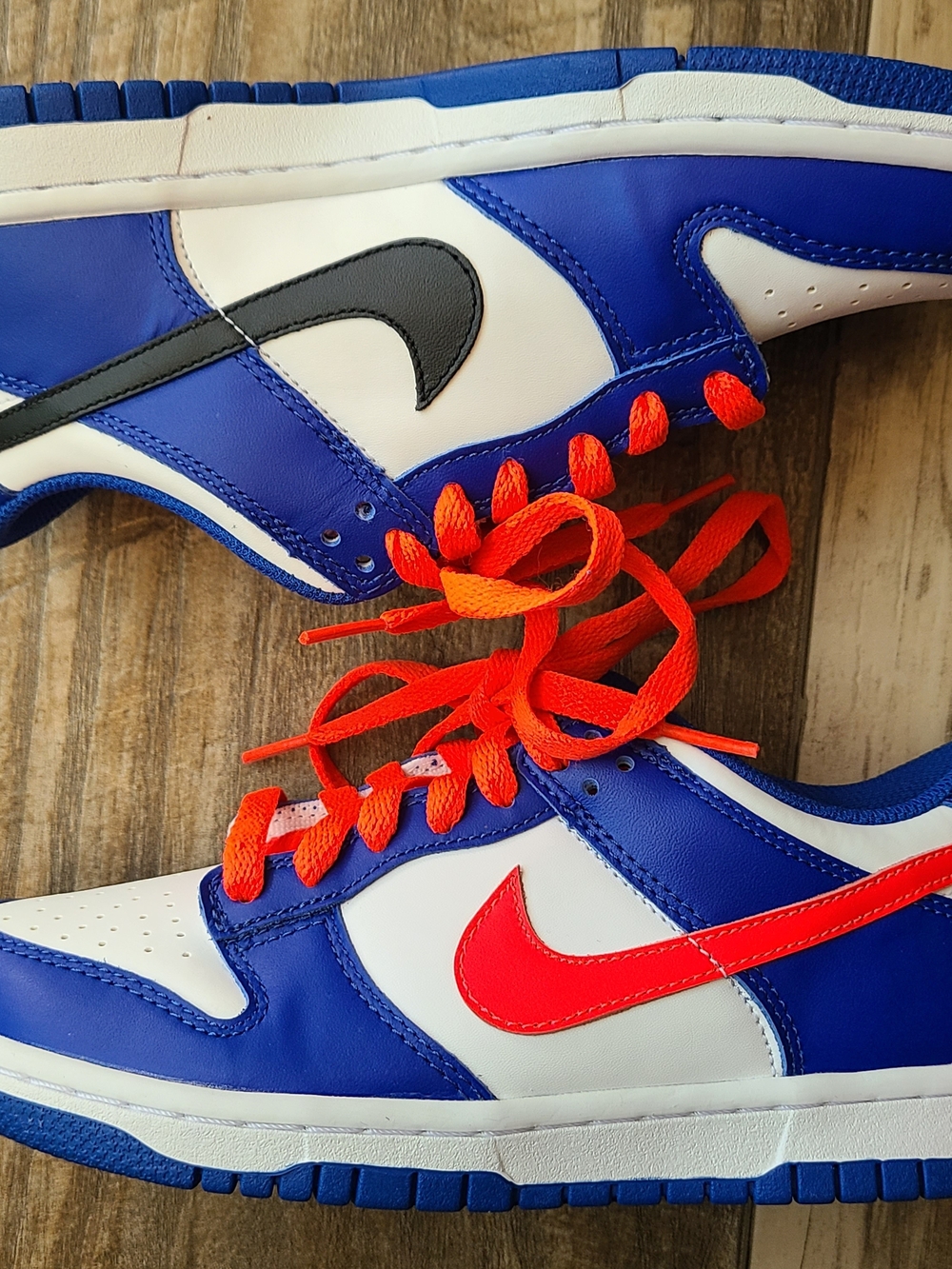 Nike Kids Blue, White & Orange Sneakers with Bright Orange Laces.